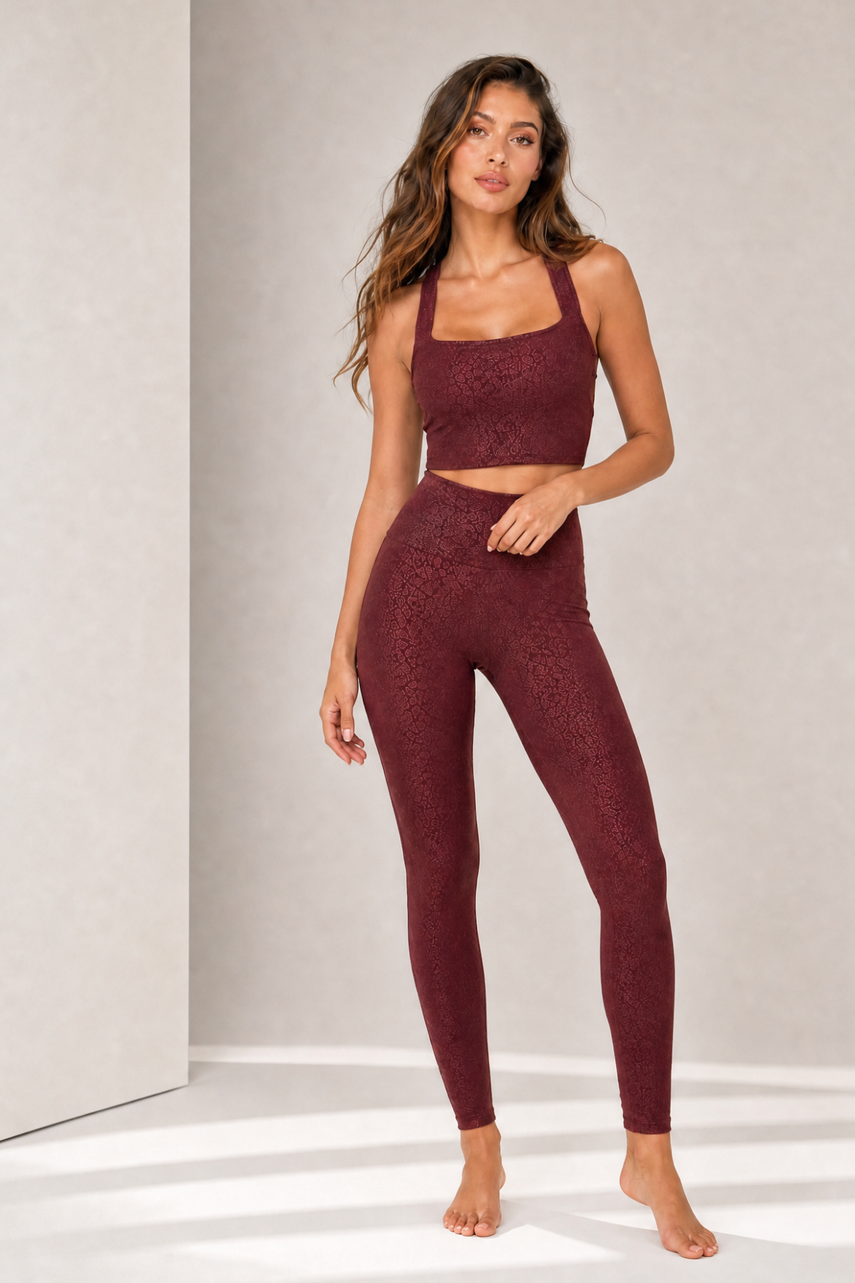 Model wearing the Natalie Bordeaux Jacquard activewear crop top with matching Lisi Bordeaux Jacquard high-waisted leggings. This coordinated workout set features a square neckline, wide supportive straps, sculpting compression fit, and soft tonal jacquard fabric for yoga, Pilates, training, and everyday athleisure.