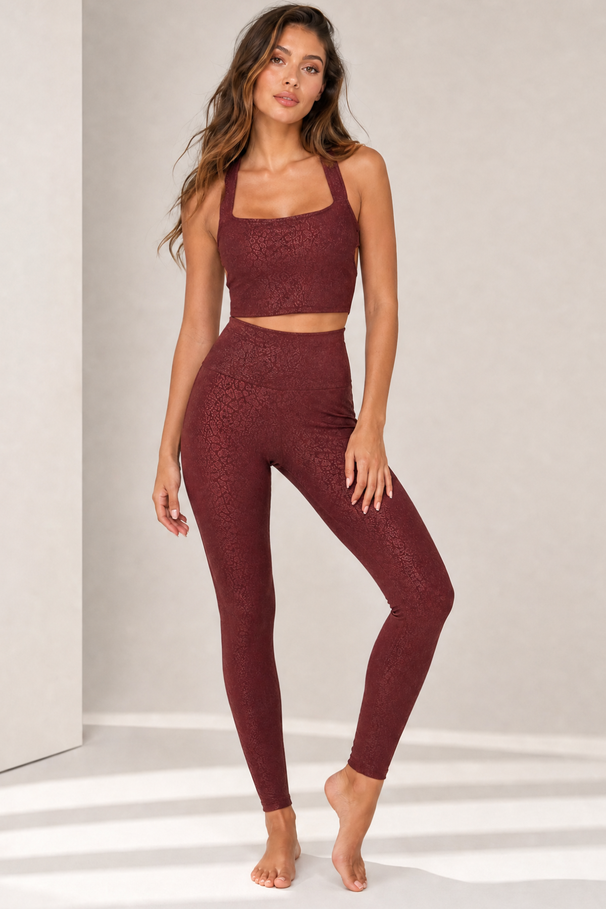 Model wearing the Natalie Bordeaux Jacquard sports crop top with matching Lisi high-waisted leggings. The supportive square-neck silhouette, soft stretch performance fabric, and subtle tonal jacquard texture create a flattering activewear set for yoga, Pilates, gym workouts, and athleisure.