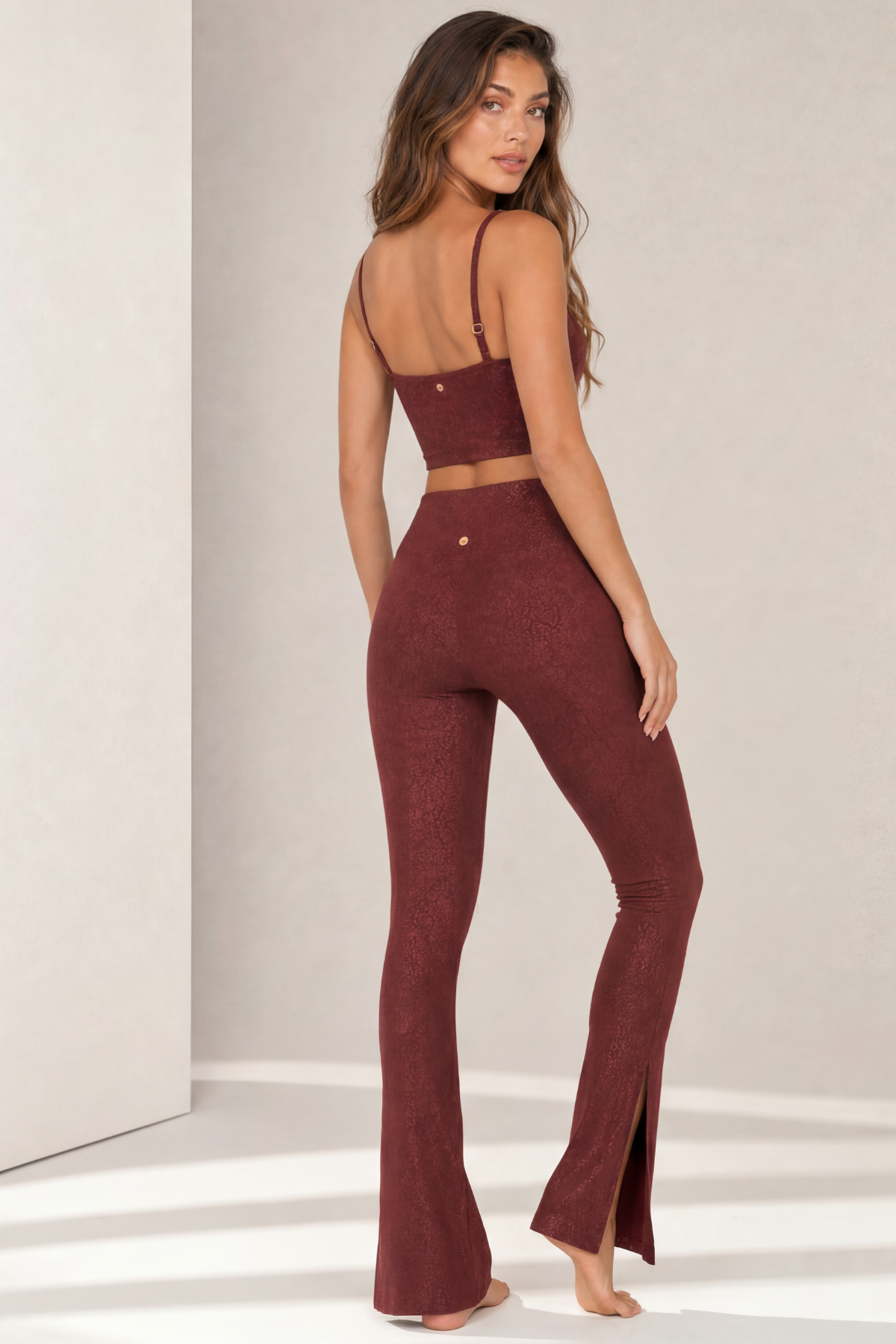 Back view of the Paxton Bordeaux Jacquard sports bra and Lisi flare leggings. The adjustable straps, supportive longline silhouette, high-rise waistband, and flattering flared leg create a comfortable and stylish activewear set for studio workouts and casual wear.